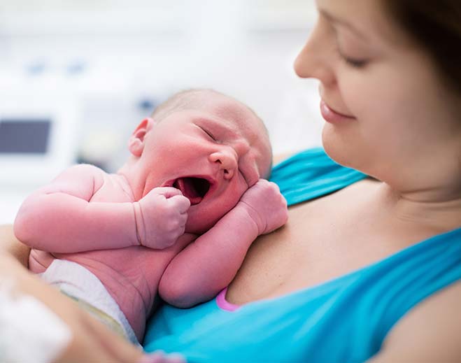 mother holding newborn baby